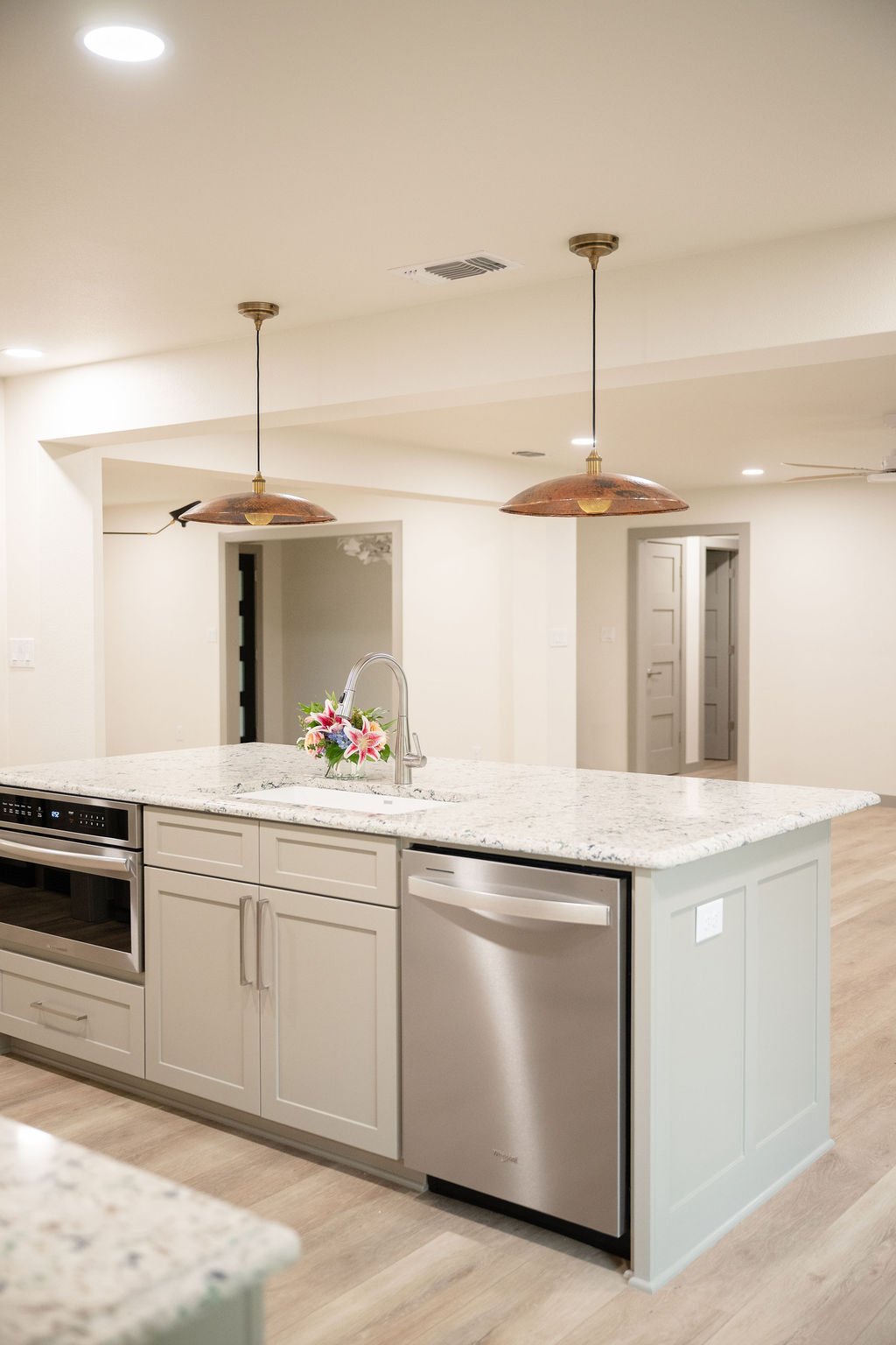 Neutral Kitchen with Featured Lighting above Island