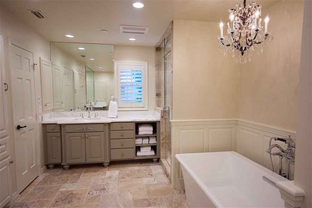 Off-White Bathroom with Tub and Giant Mirror Above Single Sink