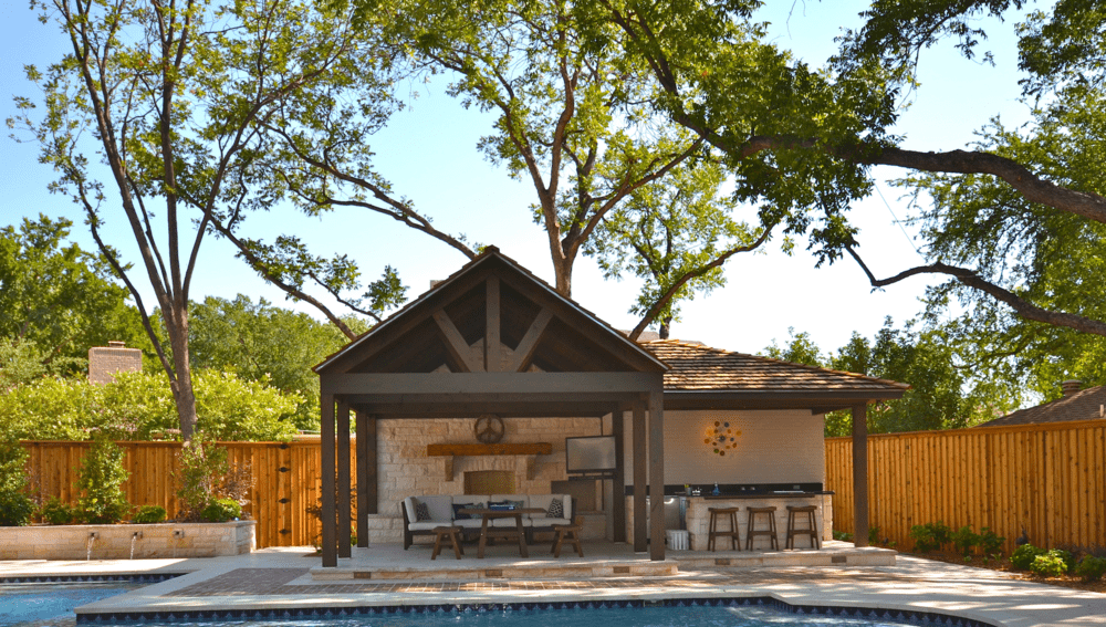 Outdoor Area with Couch and Tables Next to the Pool