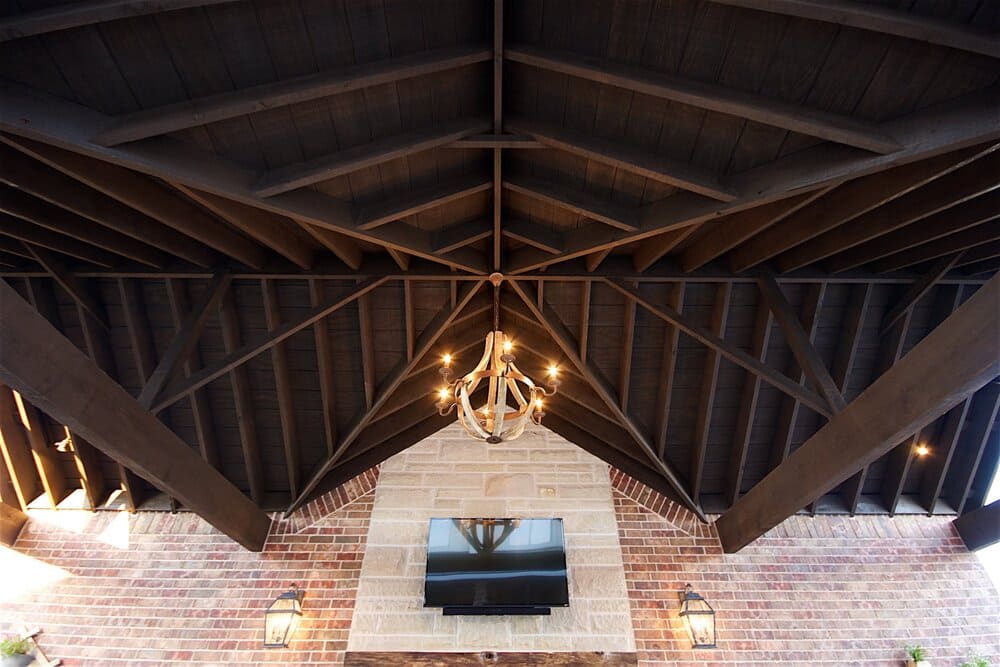 Beautiful Wooded Cabana with Light Hanging Down and Television on the Wall