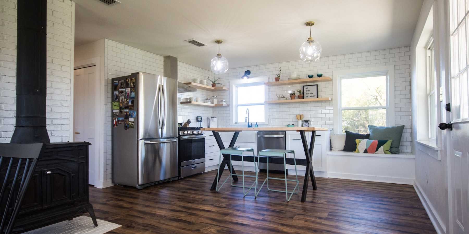 Rustic Kitchen Featuring Dark Wood Floor and Large Bright Windowss