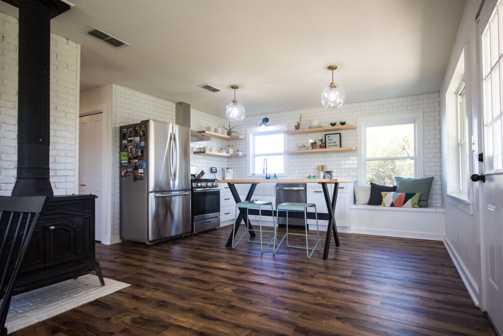 Rustic Kitchen Featuring Dark Wood Floor and Large Bright Windowss