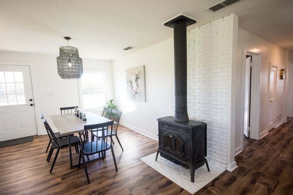 Indoor Space with Black Furnace and Minimalist Table and Chairs