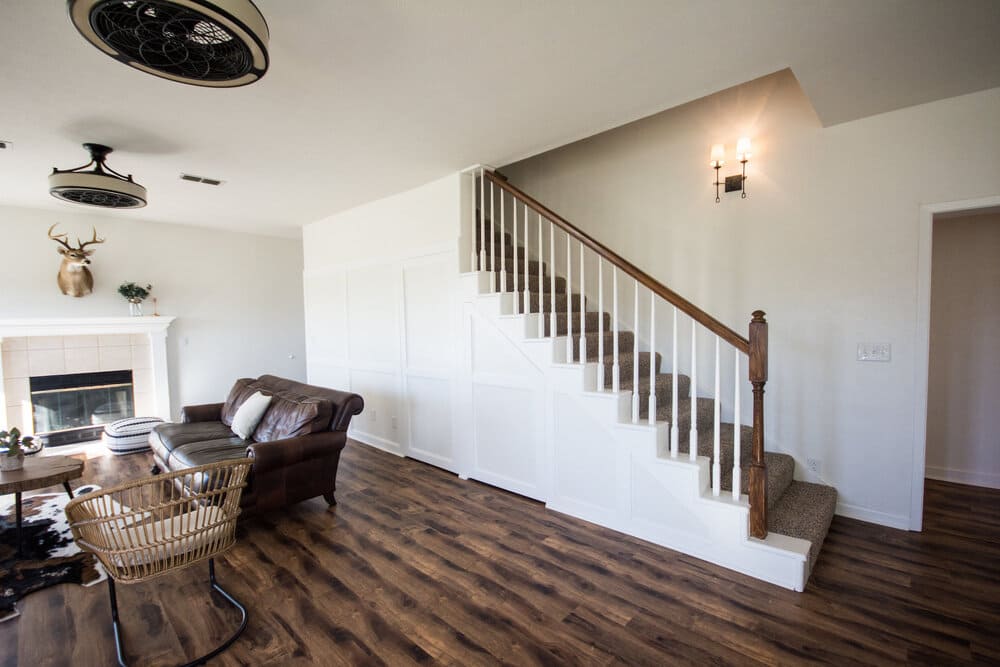 Dark Modern Living Area with Dark Brown Couch and Stag Head Mounted Over Fireplace