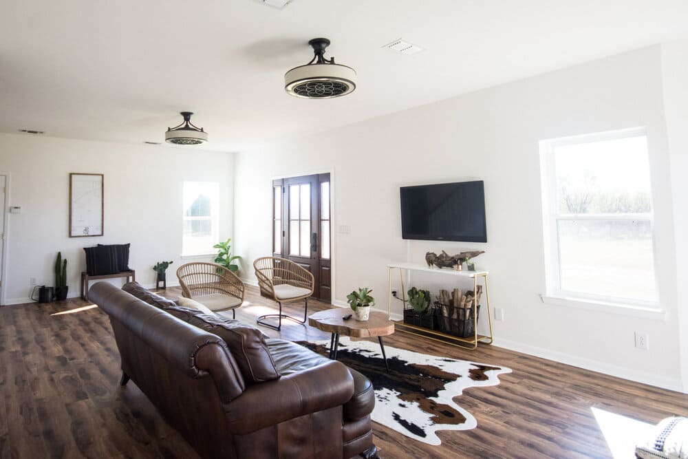 Living room with cow hide rug and chair.