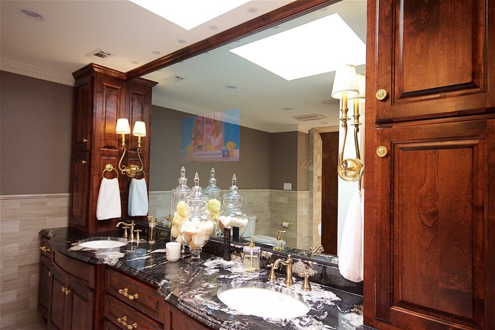 Black Speckled Countertop with Double Sink and Brass Faucets