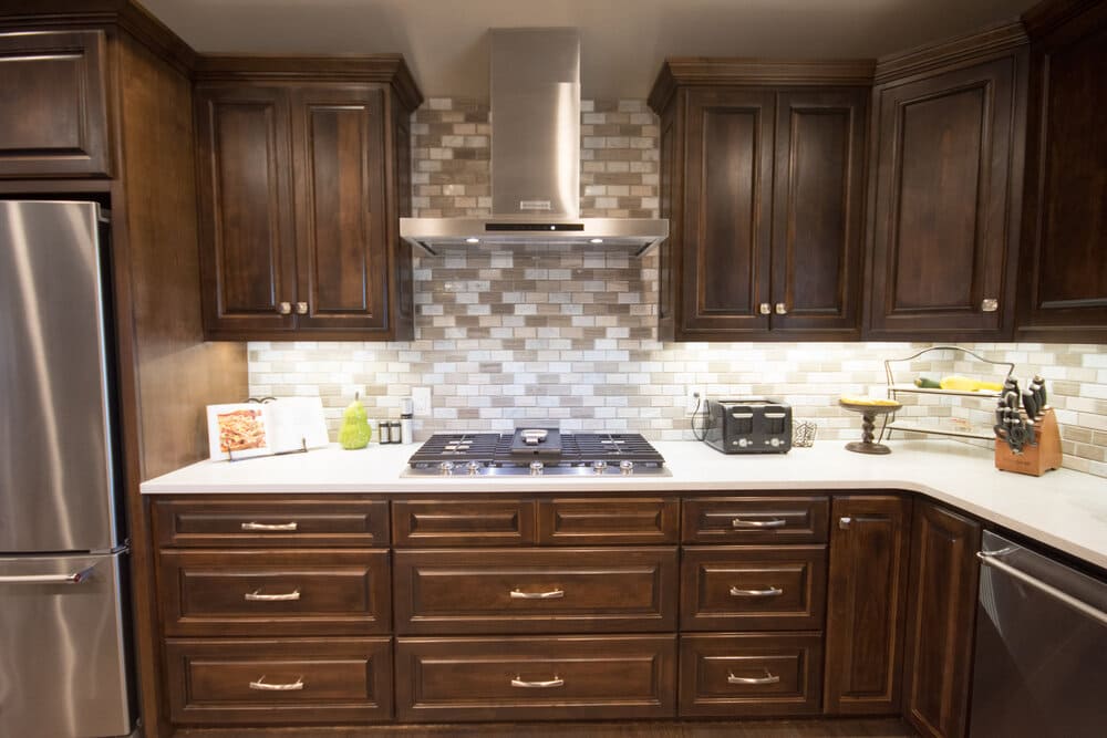 Kitchen with Dark Cabinets and Stainless Steel Fridge and Washing Machine