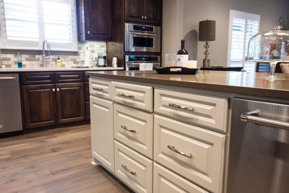Wooded Kitchen with Beige Under the Counter Storage and Stainless Steel Appliances