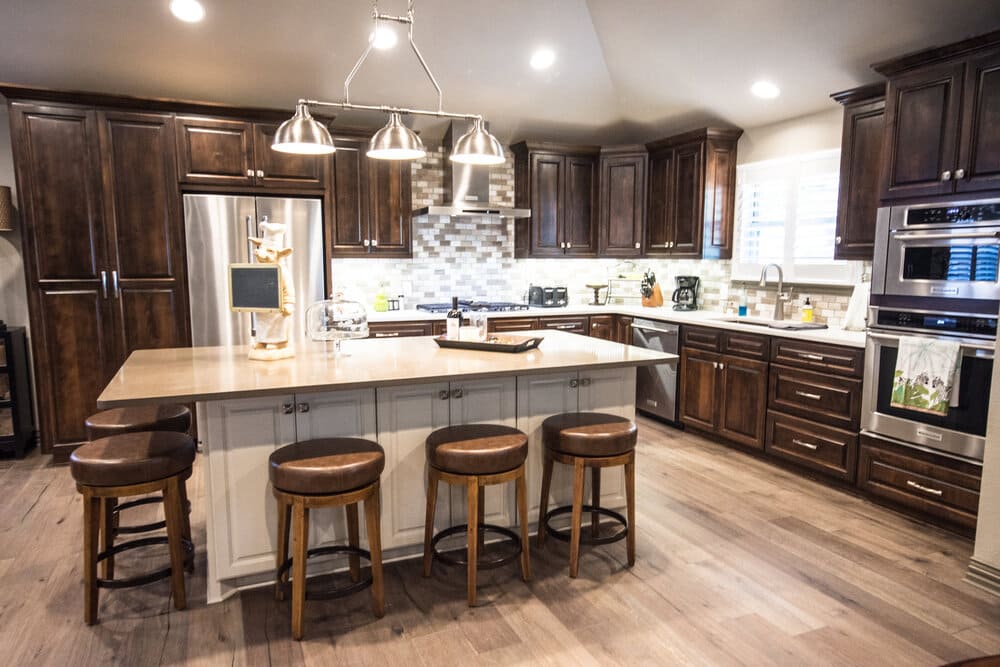 Eat-in Oversized Island and Dark Cabinets with Brown Stools