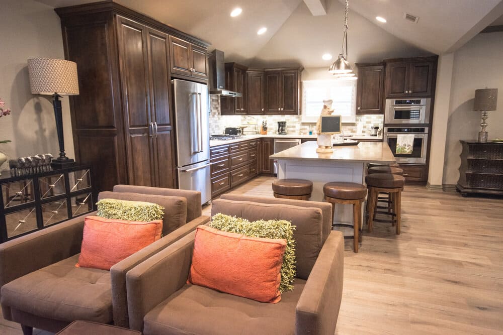 Dark Wooded Kitchen with Stainless Steel Fridge and Shiny Marble Countertop
