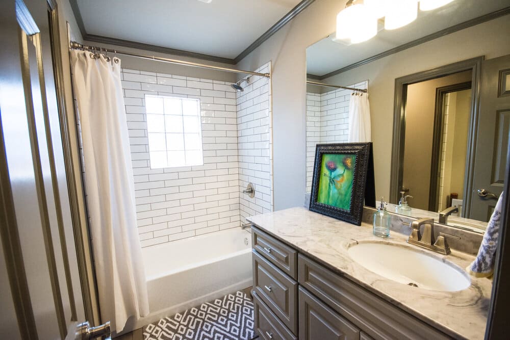 Bathroom with Single Sink and White Tiled tubed Shower
