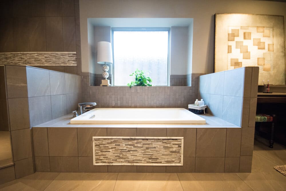 Fancy Bathroom with Tub and Window Behind