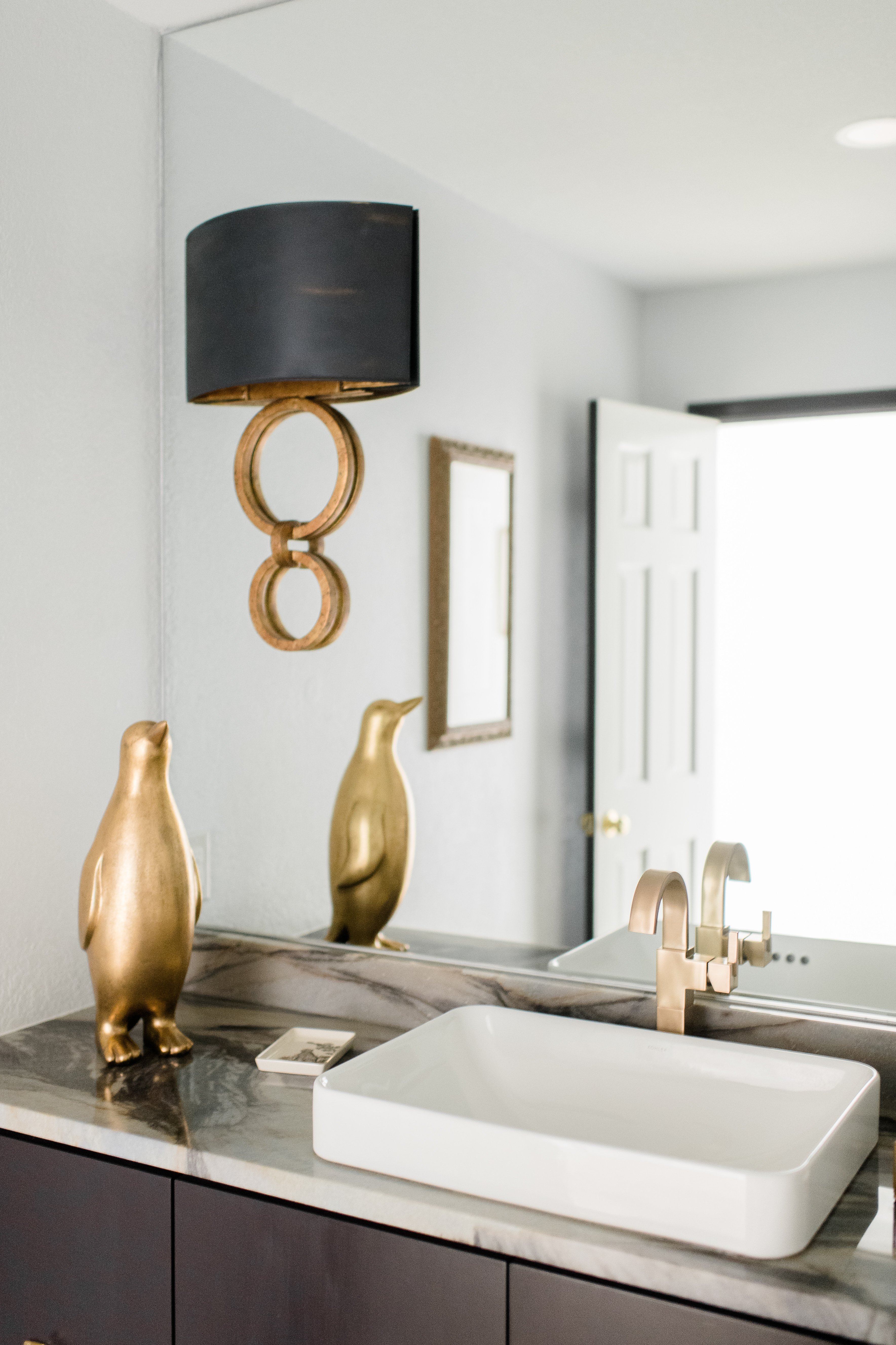 Wichita Falls Bathroom with Mirror Sconce and Dark Cabinets 