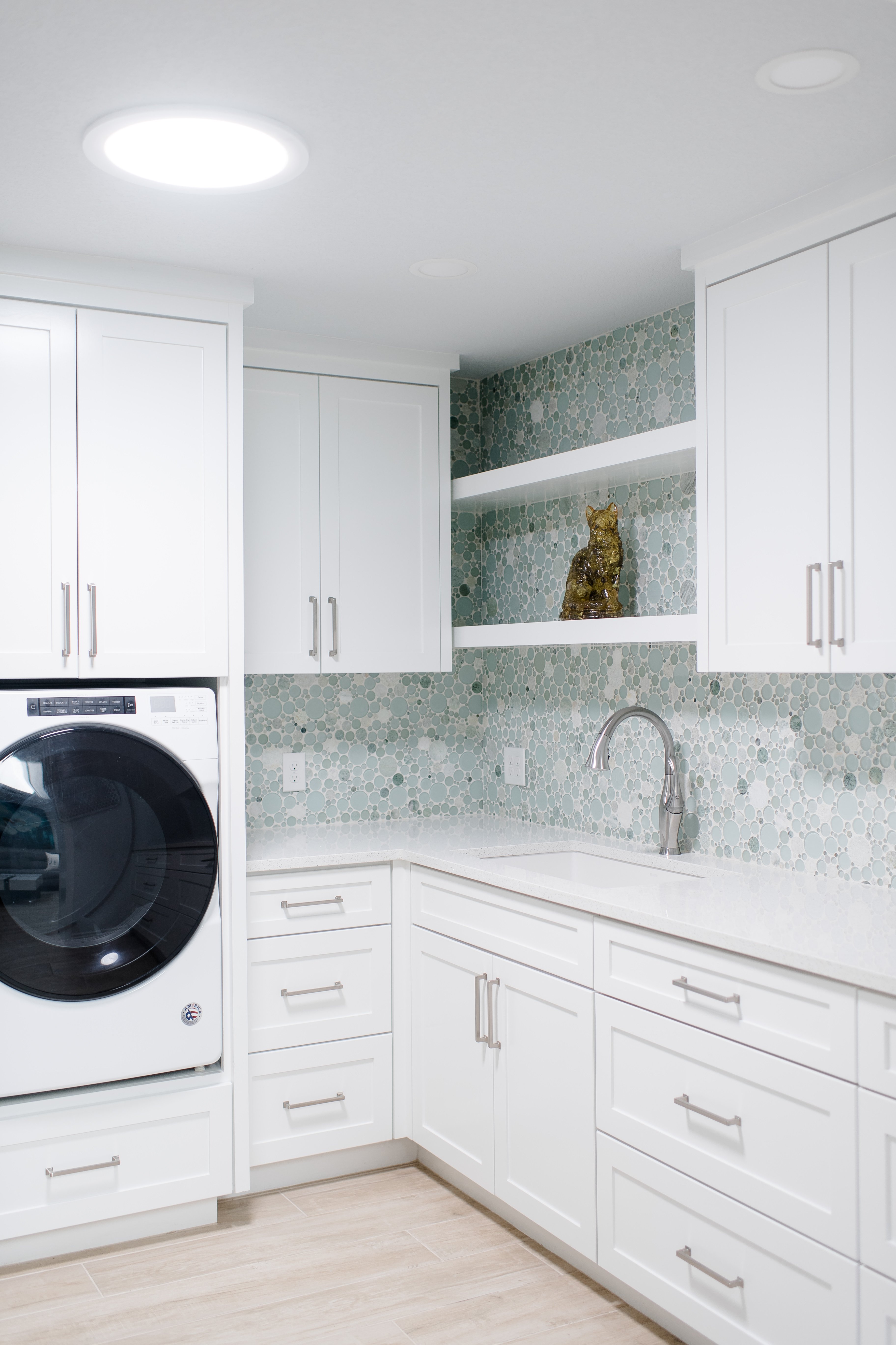 Wichita Falls Laundry Room with White Cabinets and Small Tile Backsplash