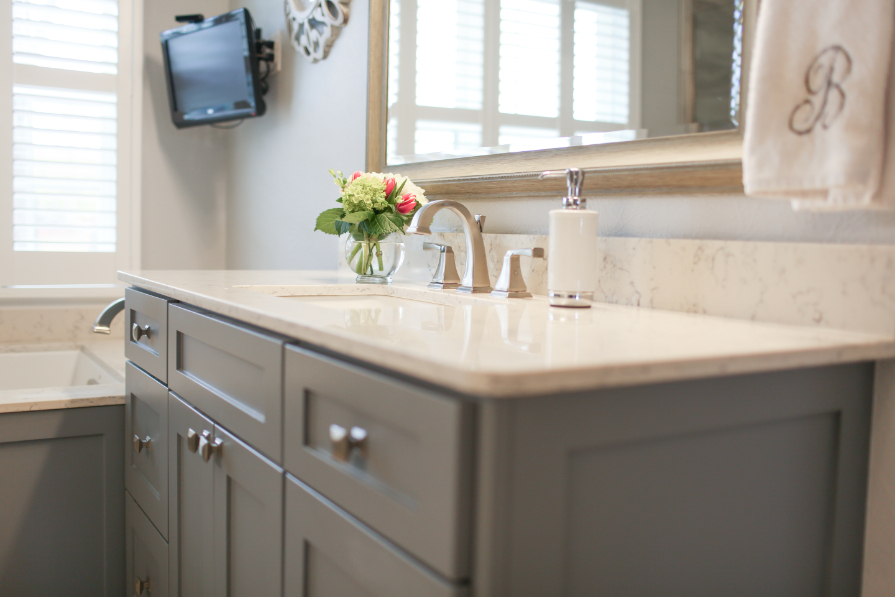 Glossy Marble Sink Next to Bathtub and Television