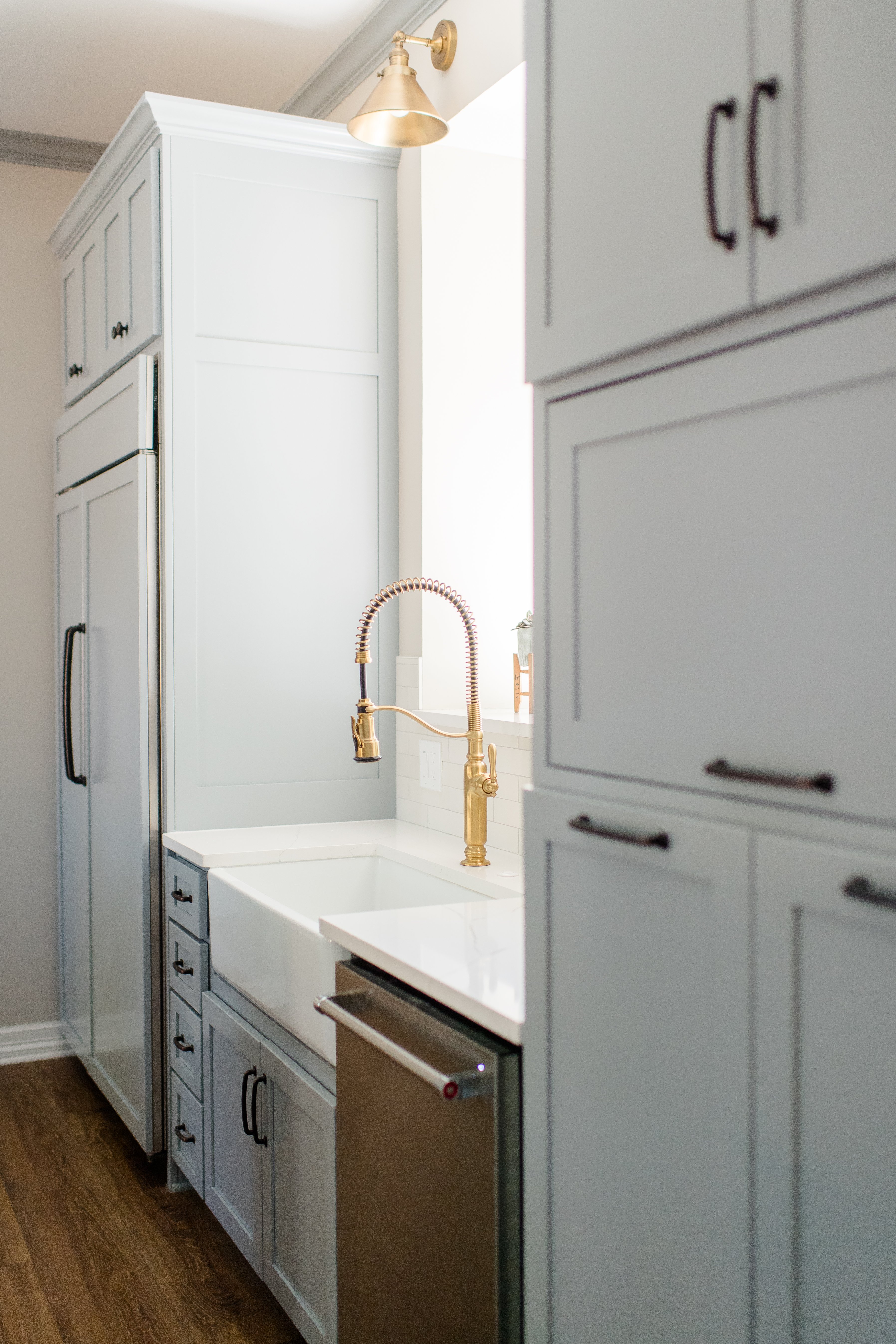 Wichita Falls Light Blue Pantry Cabinets and Gold Kitchen Faucet