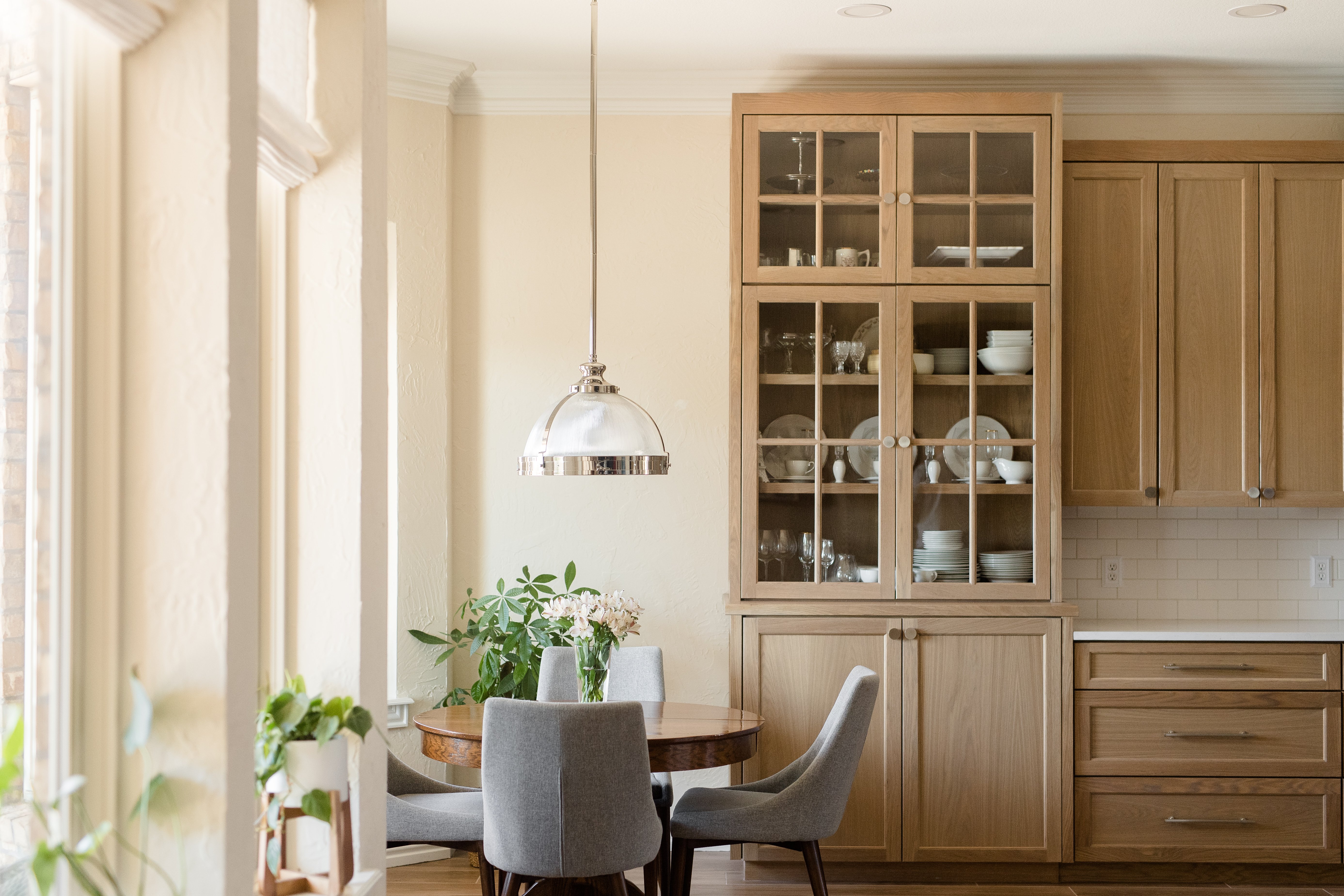 Natural Cabinets with Dining Nook & Hanging Light