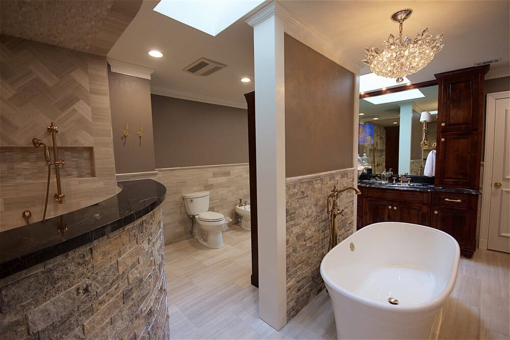 Bathroom With Freestanding Tub and Dark Wood Cabinets and Stone Backsplash
