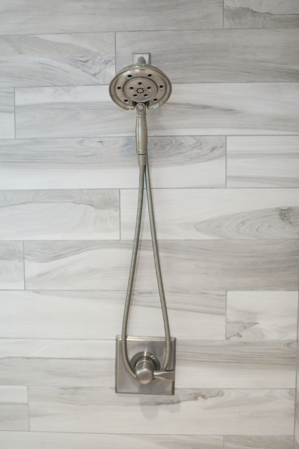Modern Shower Head on Light Grey Wooded Wall