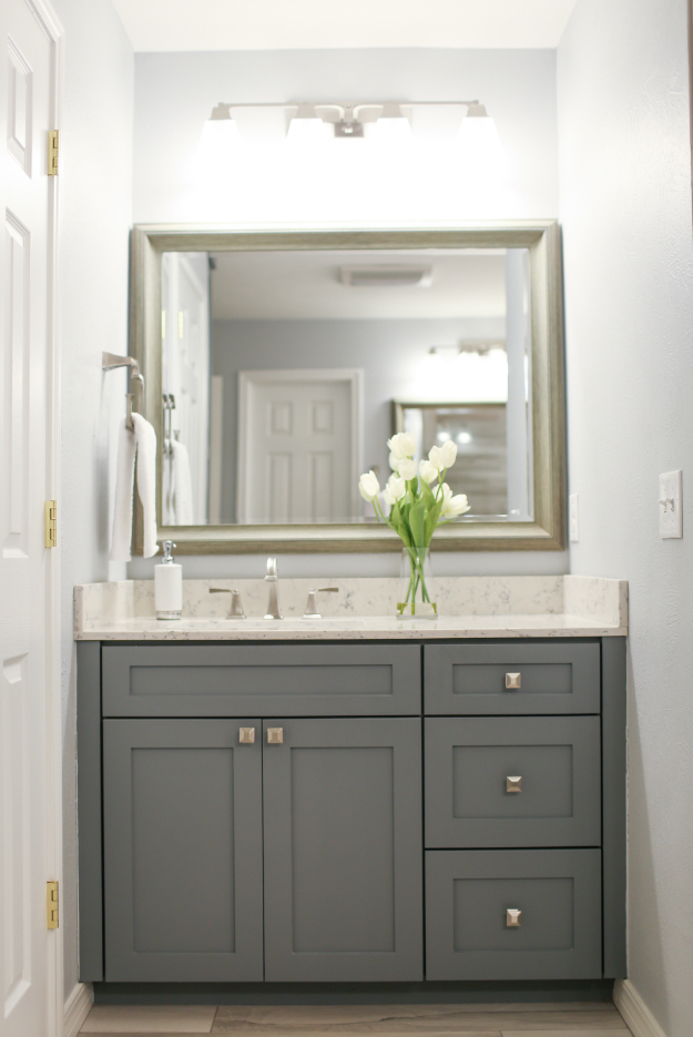 Sink with Dark Grey Cabinets and Large Mirror Behind