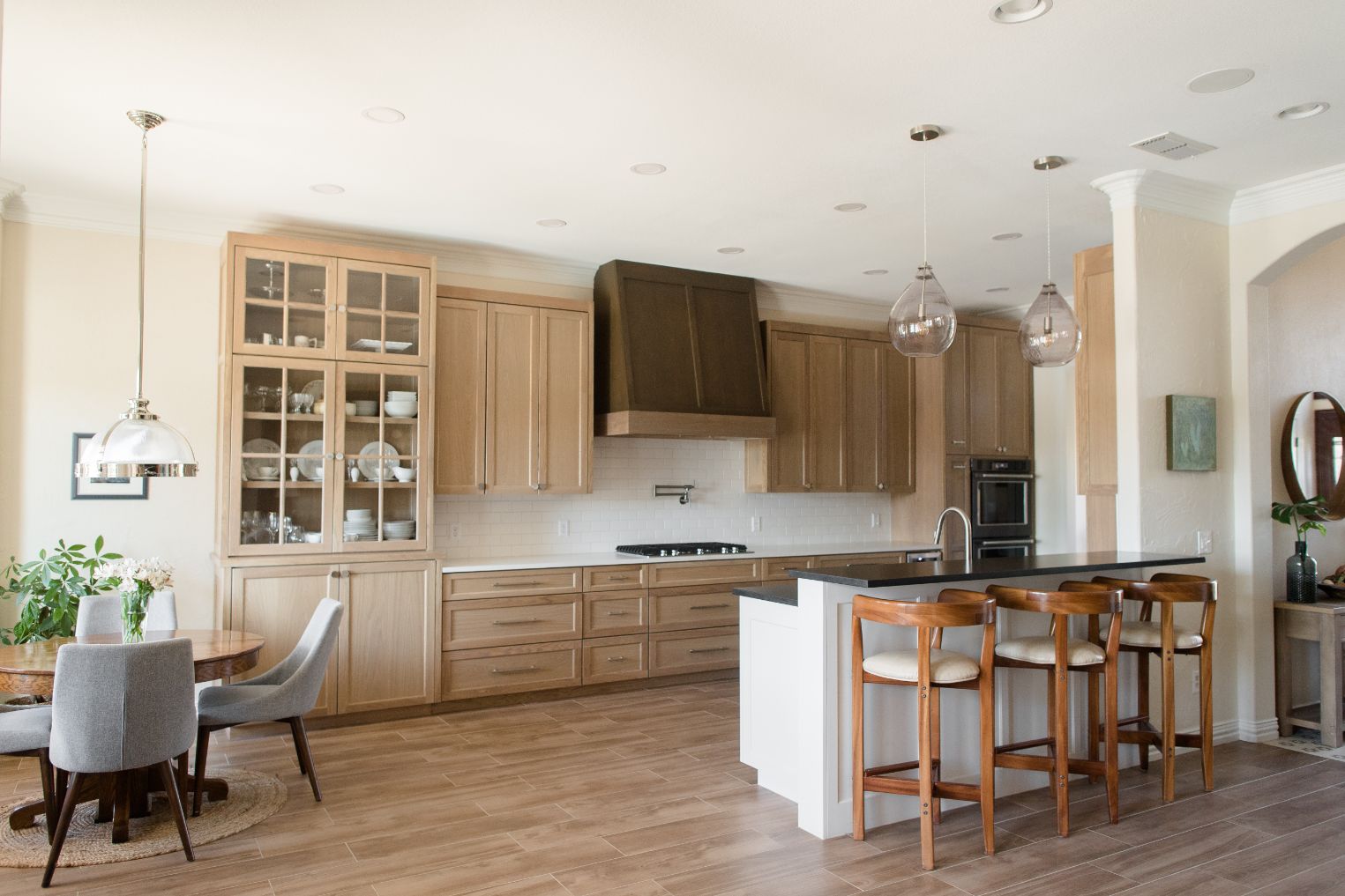 Transitional Kitchen Featuring Light Wood Floors and Accents on Cabinets